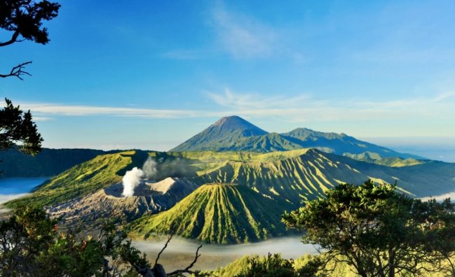 Tengger Caldera, filled with more than a dozen of mountain. The most notable one here is Mount Bromo with its smoking crater, Mount Batok in the foreground, and Mount Semeru in the far back, which is also the highest mountain in Java.